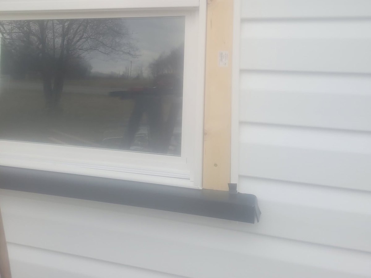 A window opening trimmed and flashed by Robinson Roofing, Elon