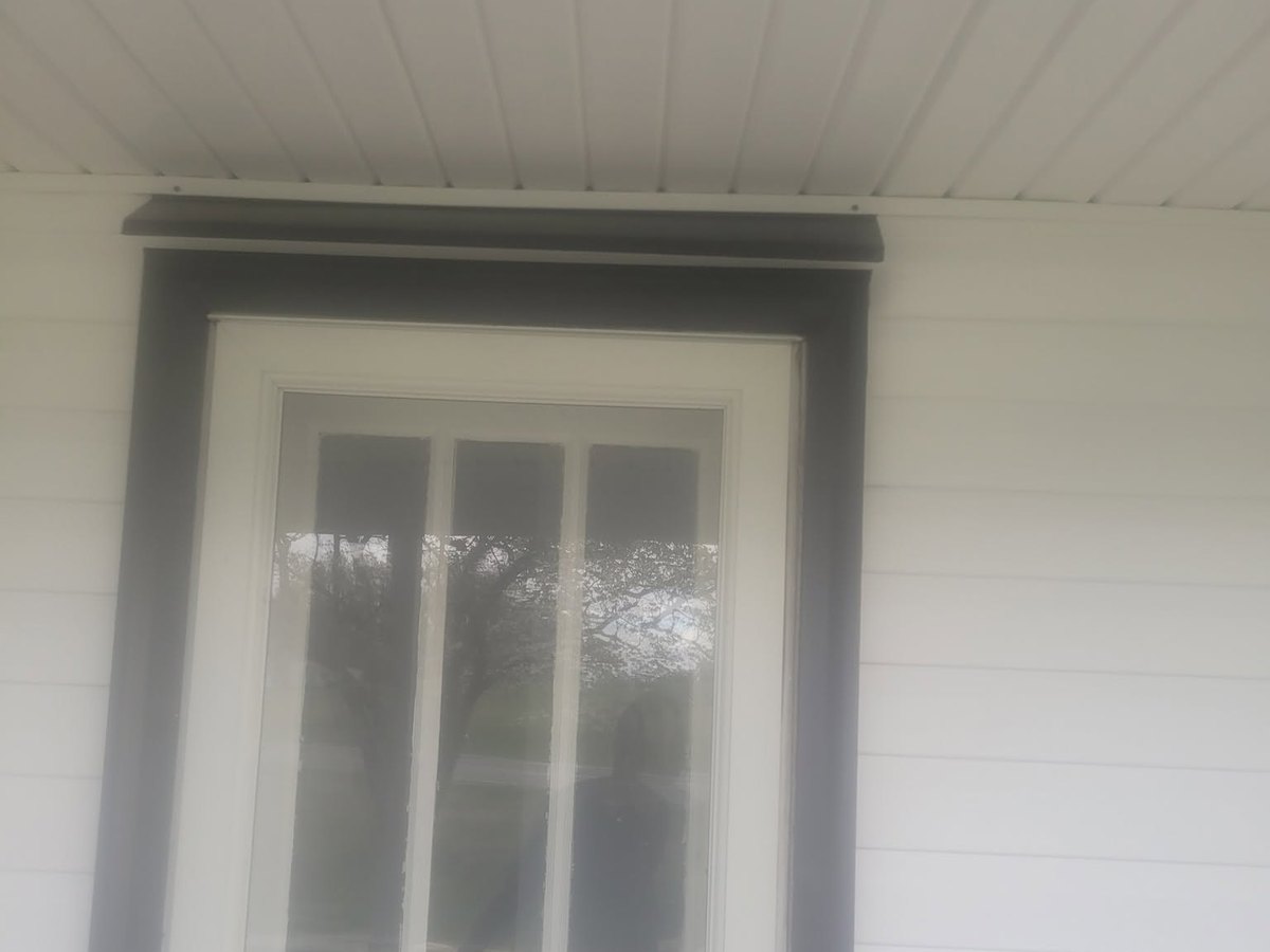 New exterior door set into its trim by Robinson Roofing, Elon
